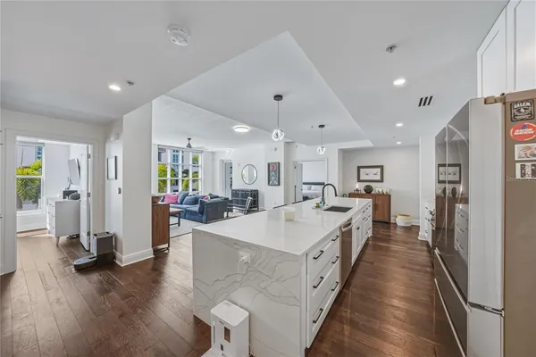 a kitchen with stainless steel appliances a sink a stove and a refrigerator