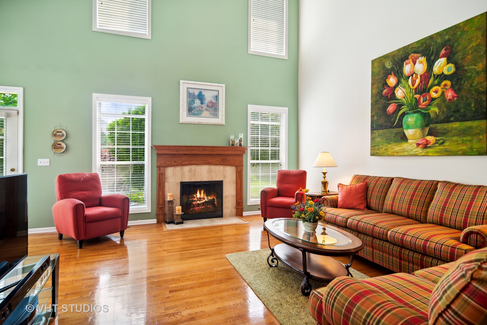 716 Fieldstone Court Inverness, IL 60010 - Photo 9 of 25 a living room with furniture a fireplace and a flat screen tv