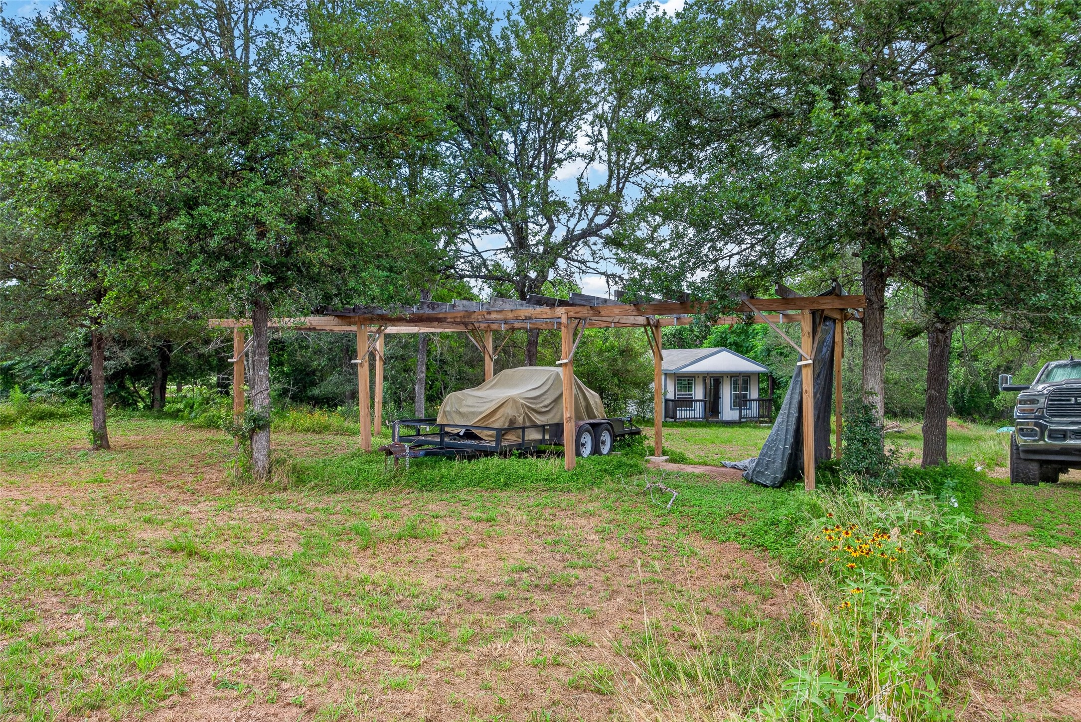 266 Beaver Road Elgin, TX 78621 - Photo 12 of 40 A quaint residence tucked amidst natural greenery, offering a peaceful outdoor setting.