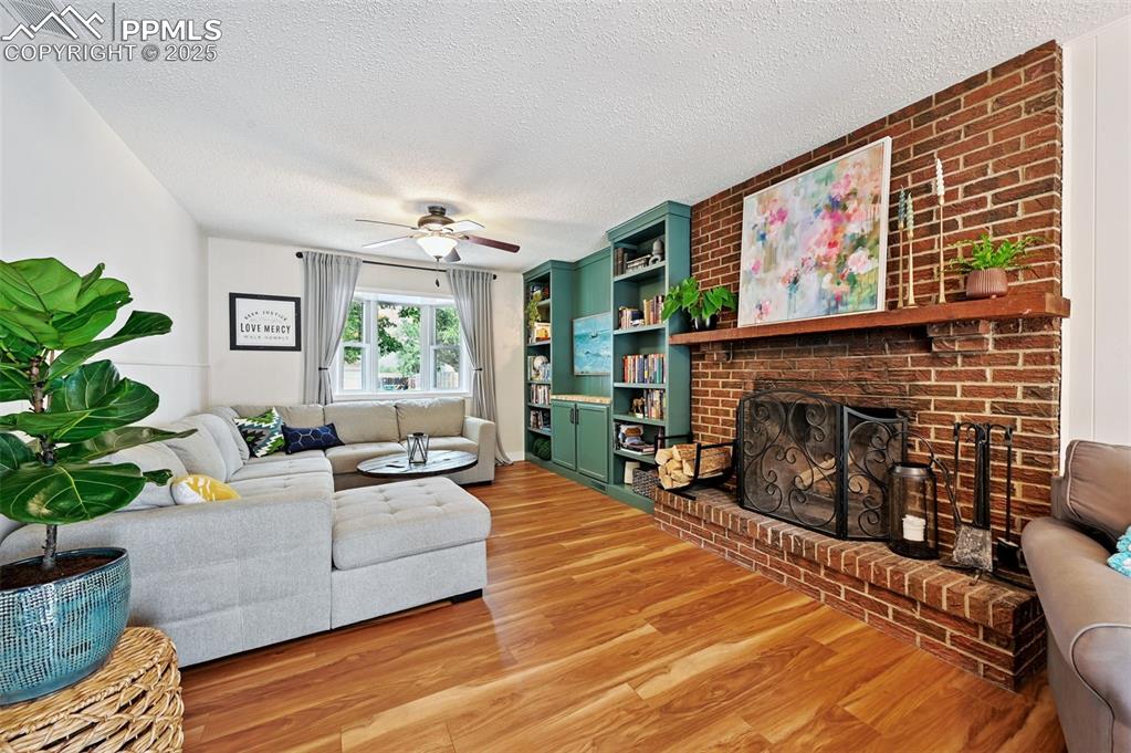 5139 Villa Circle Colorado Springs, CO 80918 - Photo 14 of 40 a living room with furniture a fireplace and a flat screen tv