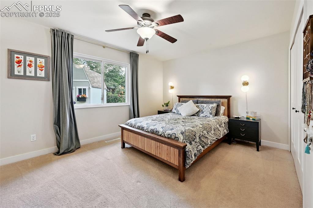 5139 Villa Circle Colorado Springs, CO 80918 - Photo 21 of 40 a bedroom with a bed and a large window