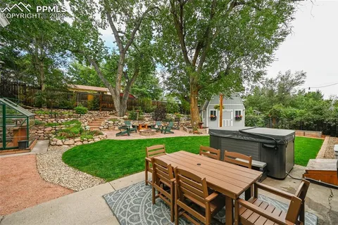 a view of a backyard with plants and outdoor seating