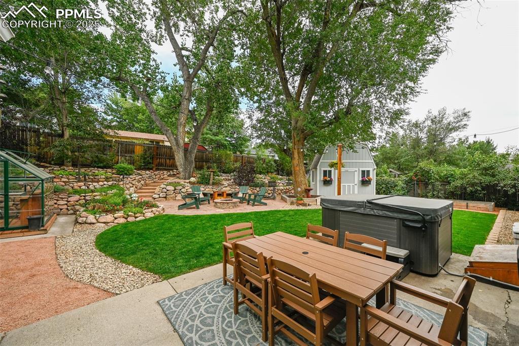 5139 Villa Circle Colorado Springs, CO 80918 - Photo 29 of 40 a view of a patio with table and chairs potted plants and a large tree
