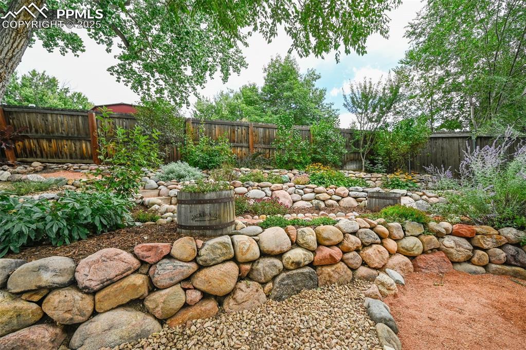 5139 Villa Circle Colorado Springs, CO 80918 - Photo 30 of 40 a view of a backyard with plants and outdoor seating