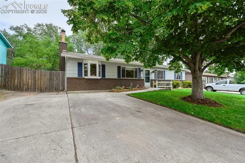 a front view of house with yard and green space