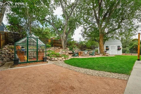 a view of a house with a backyard and a patio