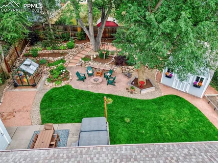 an aerial view of a house with a yard