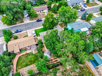 an aerial view of multiple houses with a yard