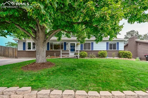 an aerial view of a house with a yard and garden