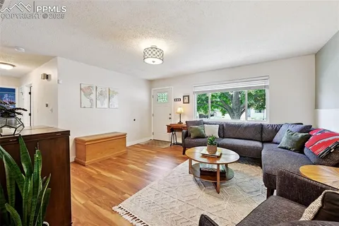 a living room with furniture a rug and a window