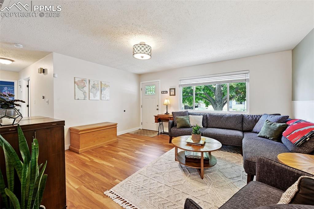 5139 Villa Circle Colorado Springs, CO 80918 - Photo 7 of 40 a living room with furniture a rug and a window