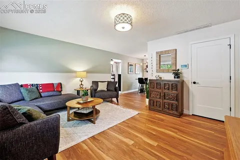 a living room with furniture and wooden floor