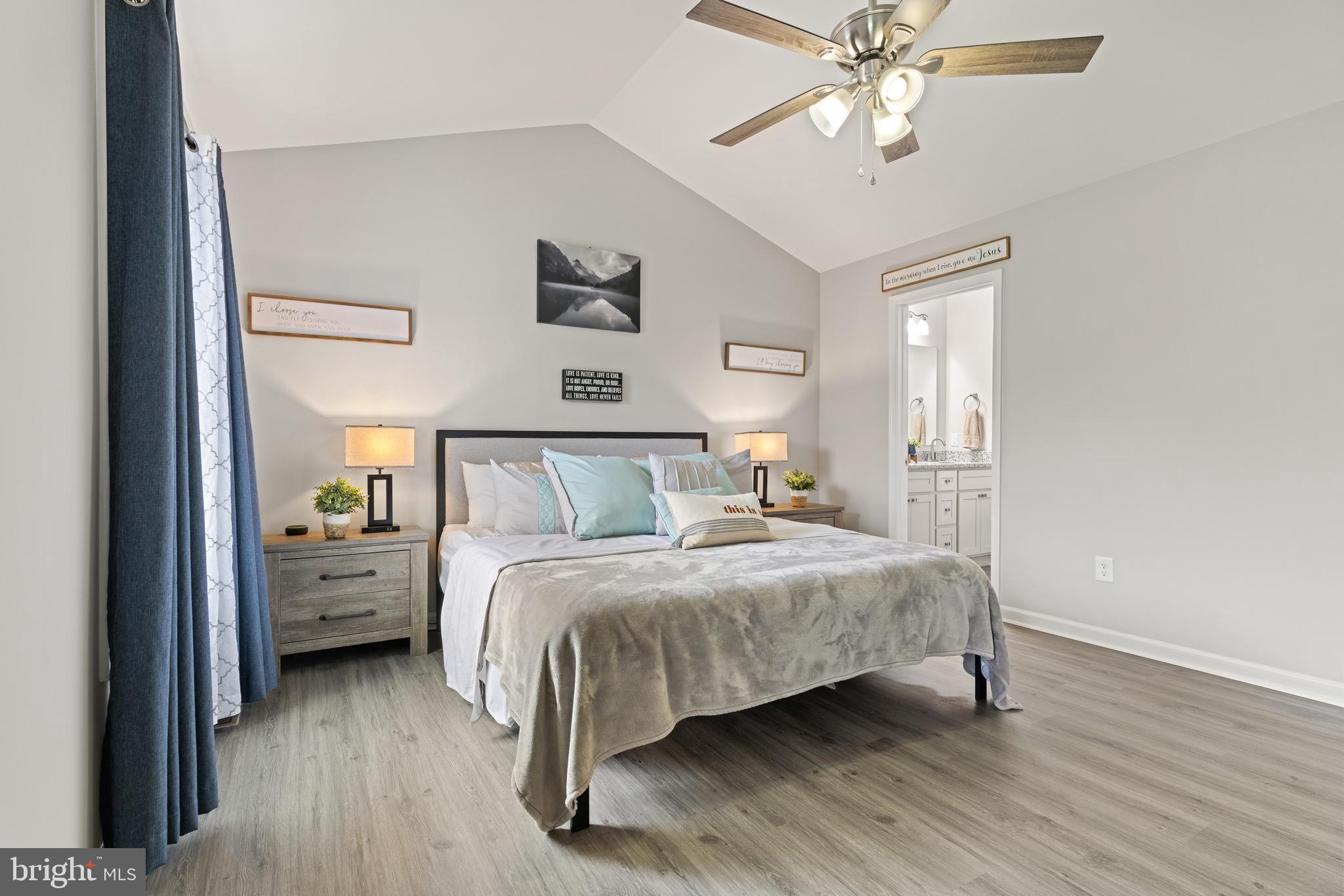 61 MDG Court Berkeley Springs, WV 25411 - Photo 21 of 47 a bedroom with a bed and a chandelier