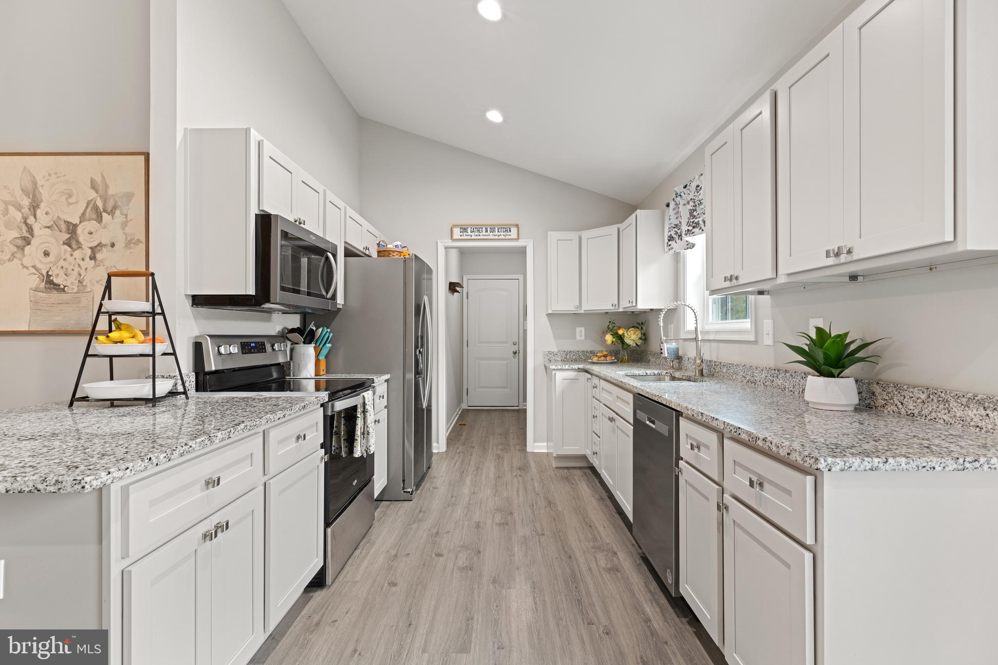 61 MDG Court Berkeley Springs, WV 25411 - Photo 32 of 47 a kitchen with granite countertop a sink cabinets stainless steel appliances and a counter space
