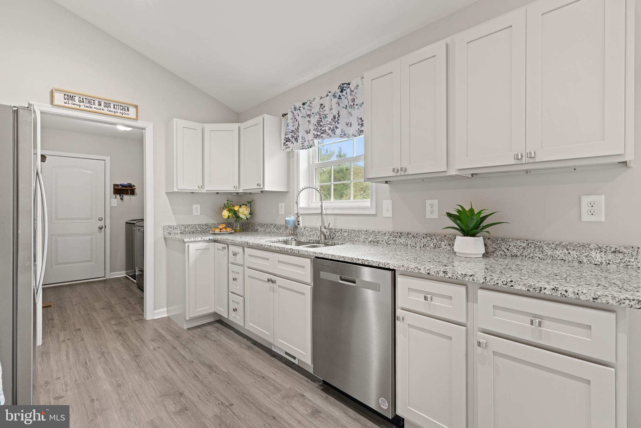 61 MDG Court Berkeley Springs, WV 25411 - Photo 33 of 47 a kitchen with white cabinets and white appliances