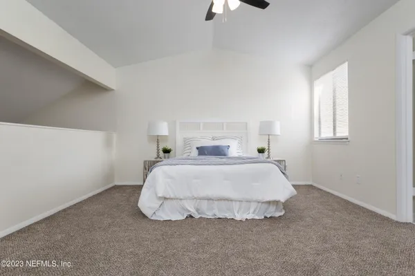 a bedroom with a bed and a window