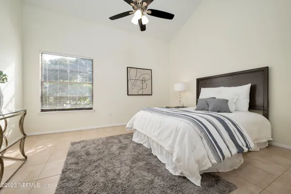 a bedroom with a bed and window