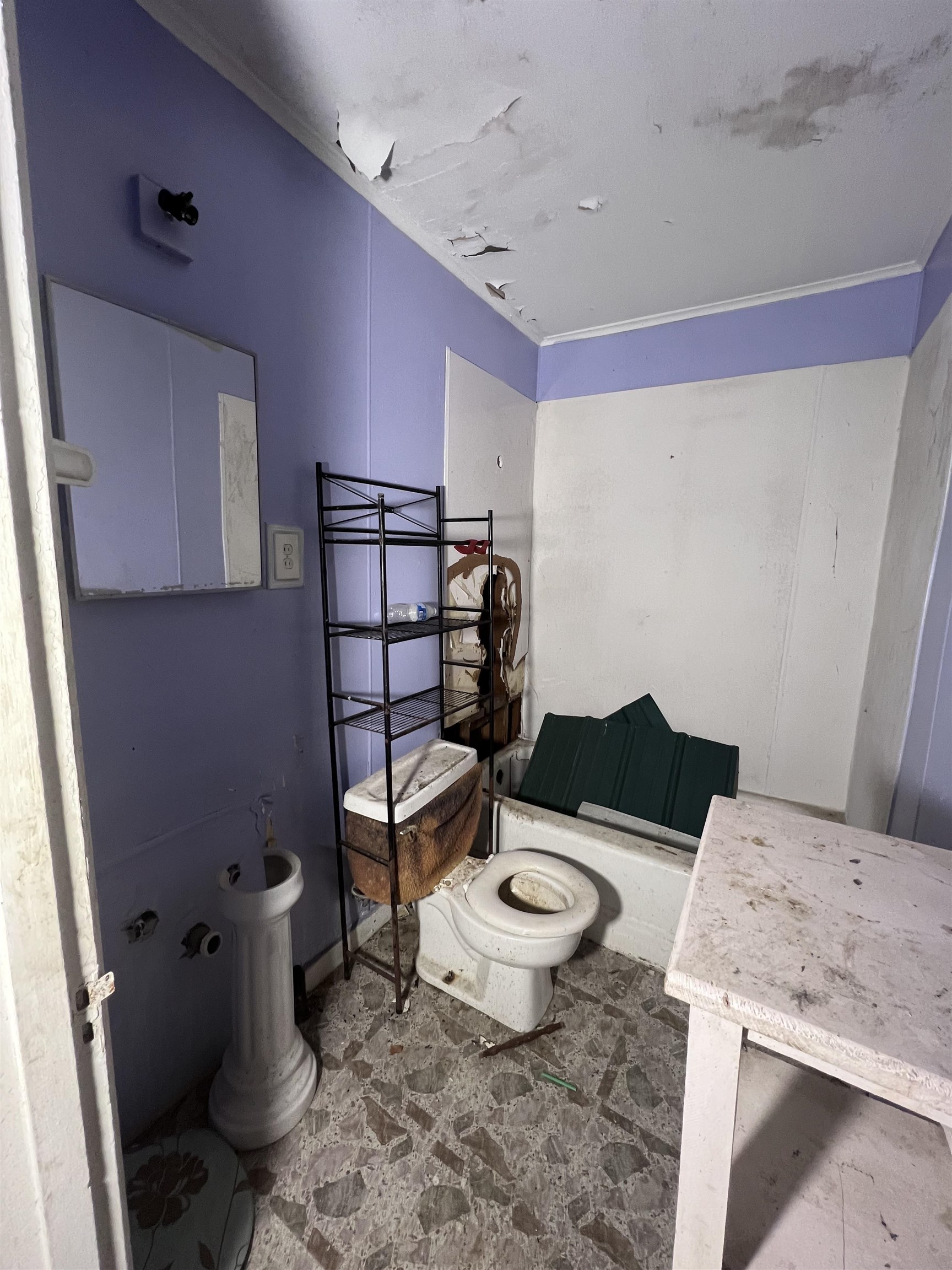 835 Baltic Street Memphis, TN 38112 - Photo 2 of 9 a bathroom with a granite countertop toilet a sink and a mirror