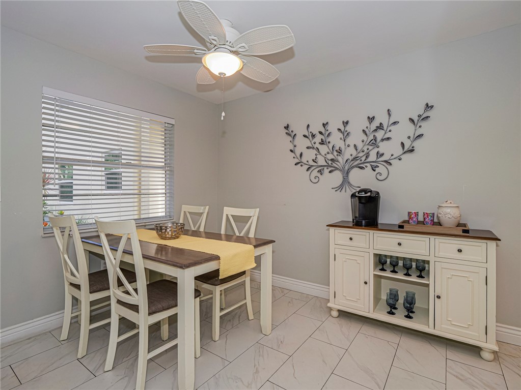 5400 Highway A1a, Unit D3 Vero Beach, FL 32963 - Photo 11 of 35 a view of a dining room that has a chandelier and a table in it