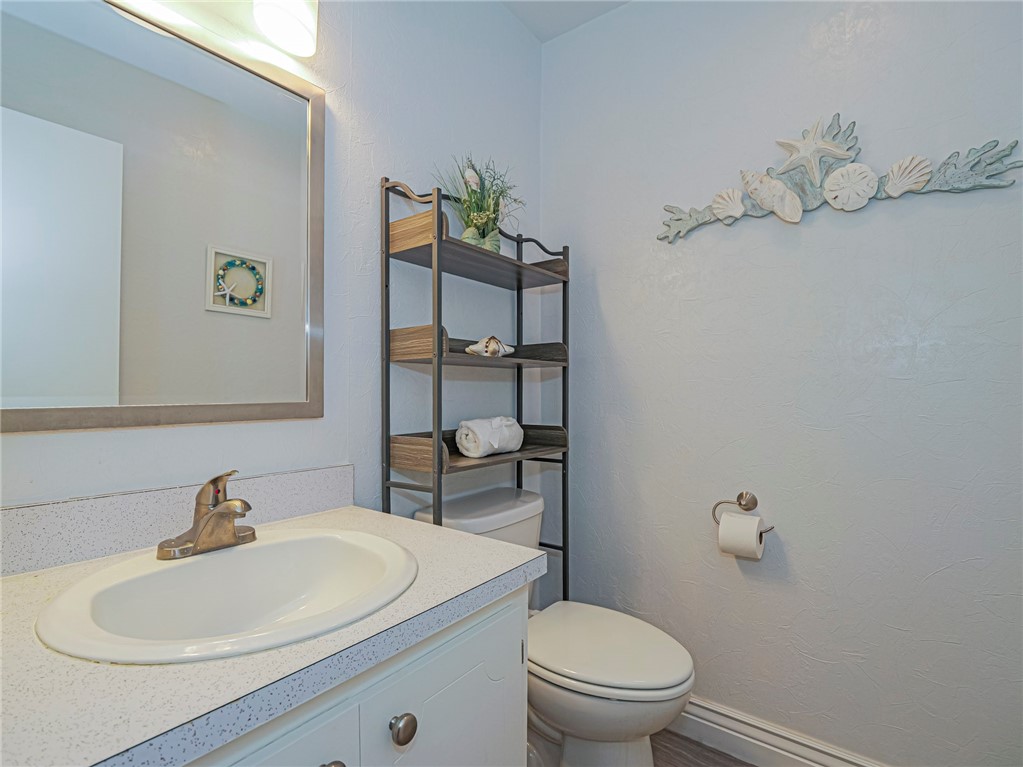 5400 Highway A1a, Unit D3 Vero Beach, FL 32963 - Photo 12 of 35 a bathroom with a sink a toilet and a mirror