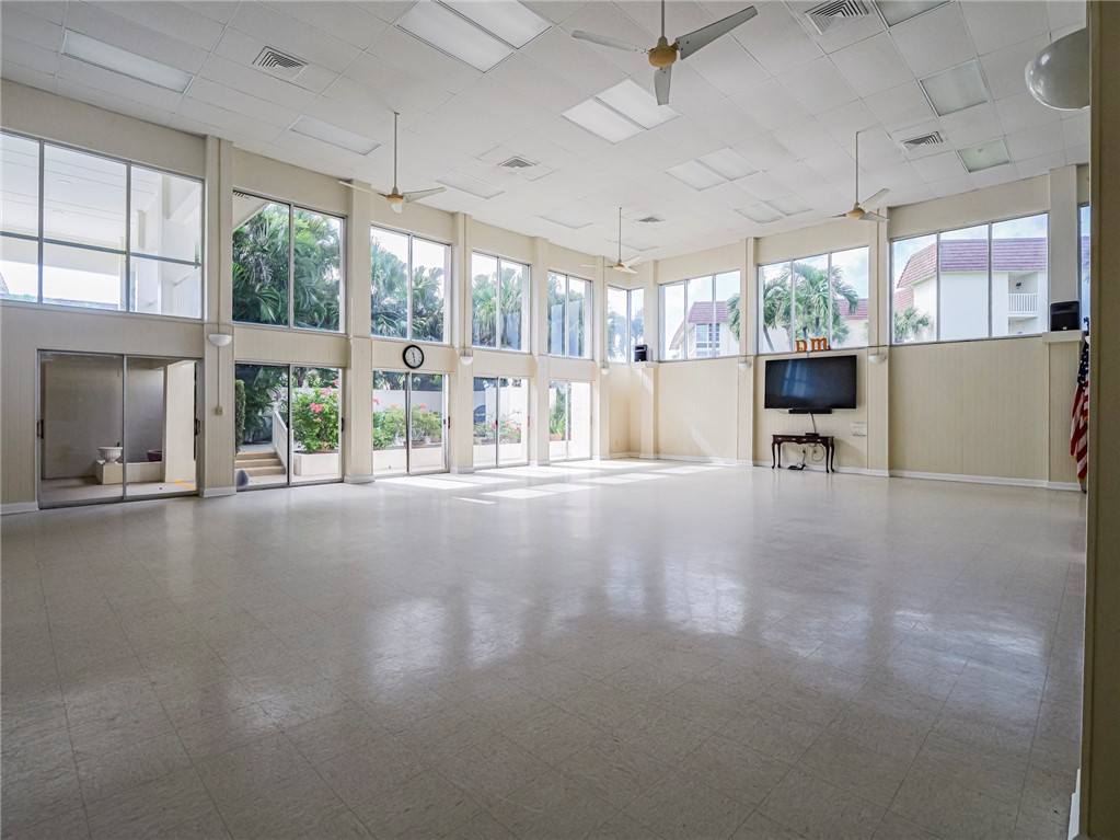 5400 Highway A1a, Unit D3 Vero Beach, FL 32963 - Photo 33 of 35 a view of an empty room with a fireplace and windows
