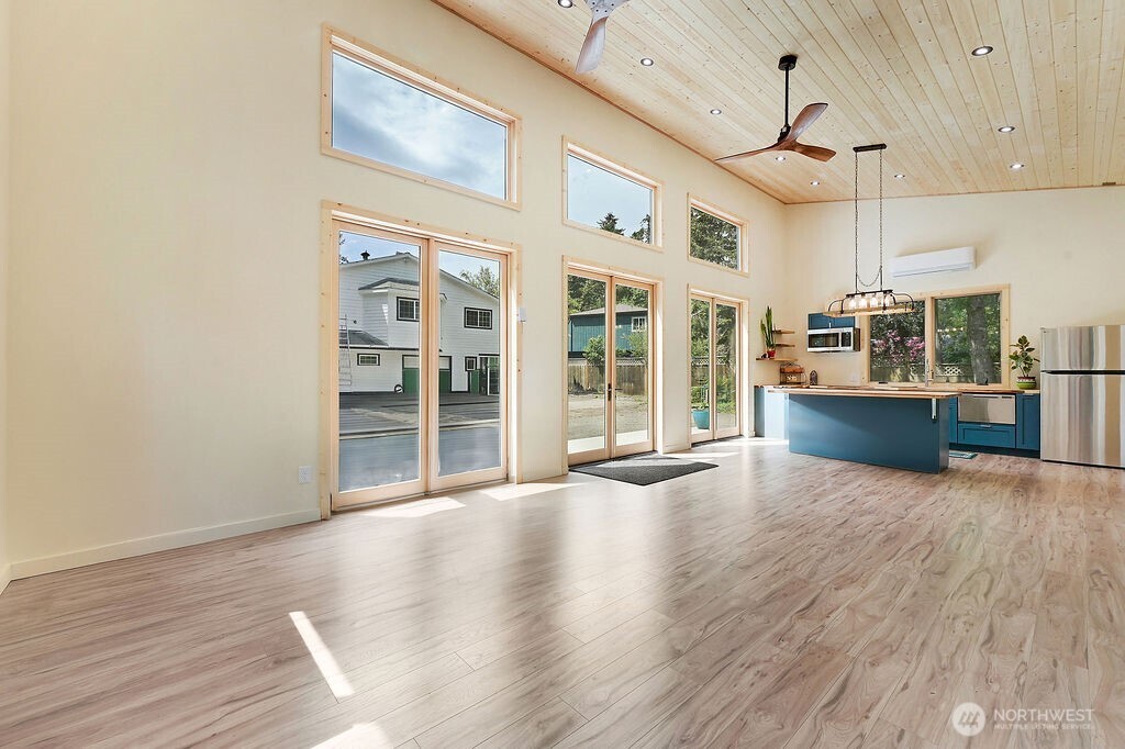 196 Nolton Road Nordland, WA 98358 - Photo 21 of 39 a view of a kitchen with wooden floor and windows