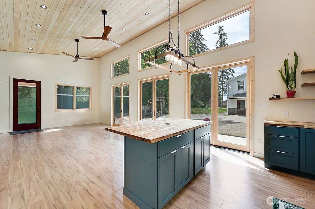 196 Nolton Road Nordland, WA 98358 - Photo 22 of 39 a kitchen with a stove and a dishwasher next to a large window