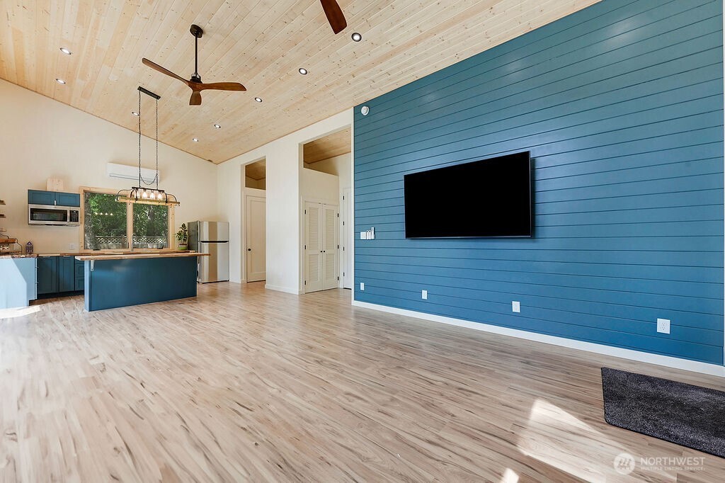 196 Nolton Road Nordland, WA 98358 - Photo 23 of 39 a view of a livingroom with a flat screen tv