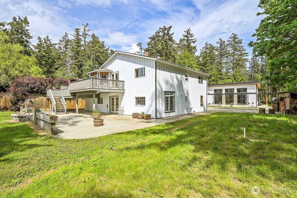196 Nolton Road Nordland, WA 98358 - Photo 33 of 39 a view of a house with a yard patio and fire pit