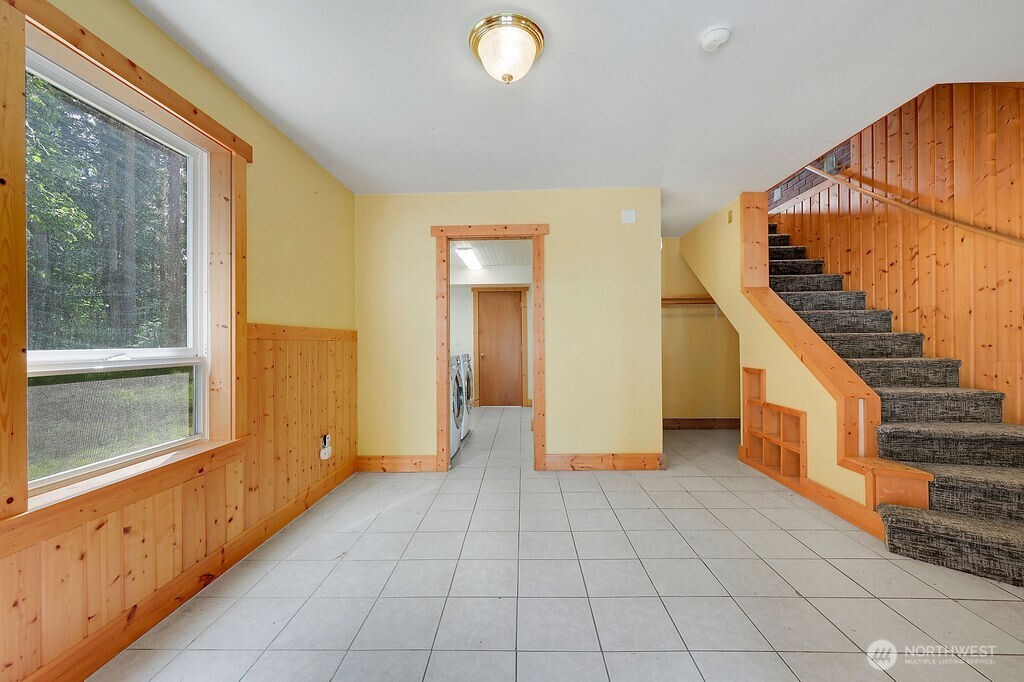 196 Nolton Road Nordland, WA 98358 - Photo 4 of 39 a view of a hallway with entryway wooden floor and cabinet