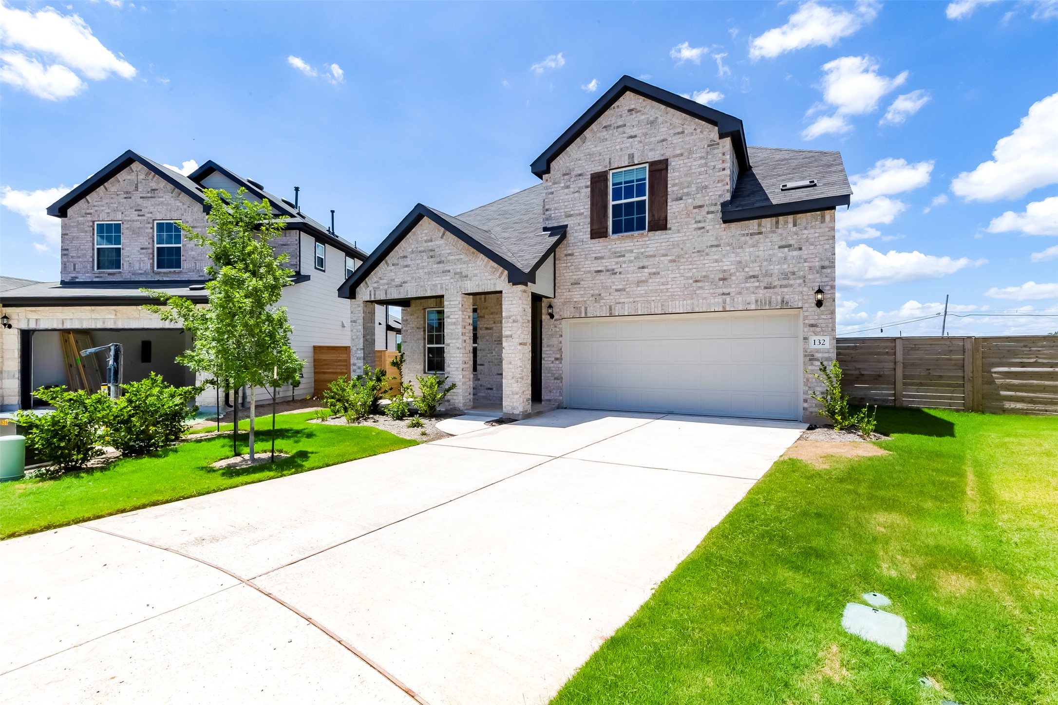132 Inlet Lane Leander, TX 78641 - Photo 2 of 36 French country style house with an attached garage, brick siding, concrete driveway, and stone siding