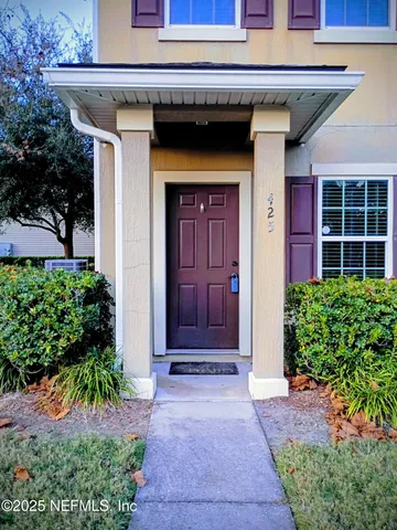 a view of front door and small yard