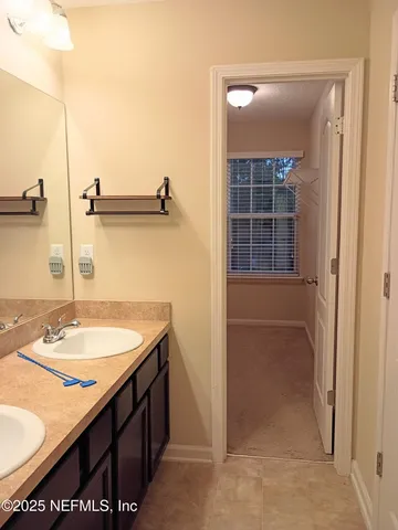 a bathroom with a sink a vanity and a mirror