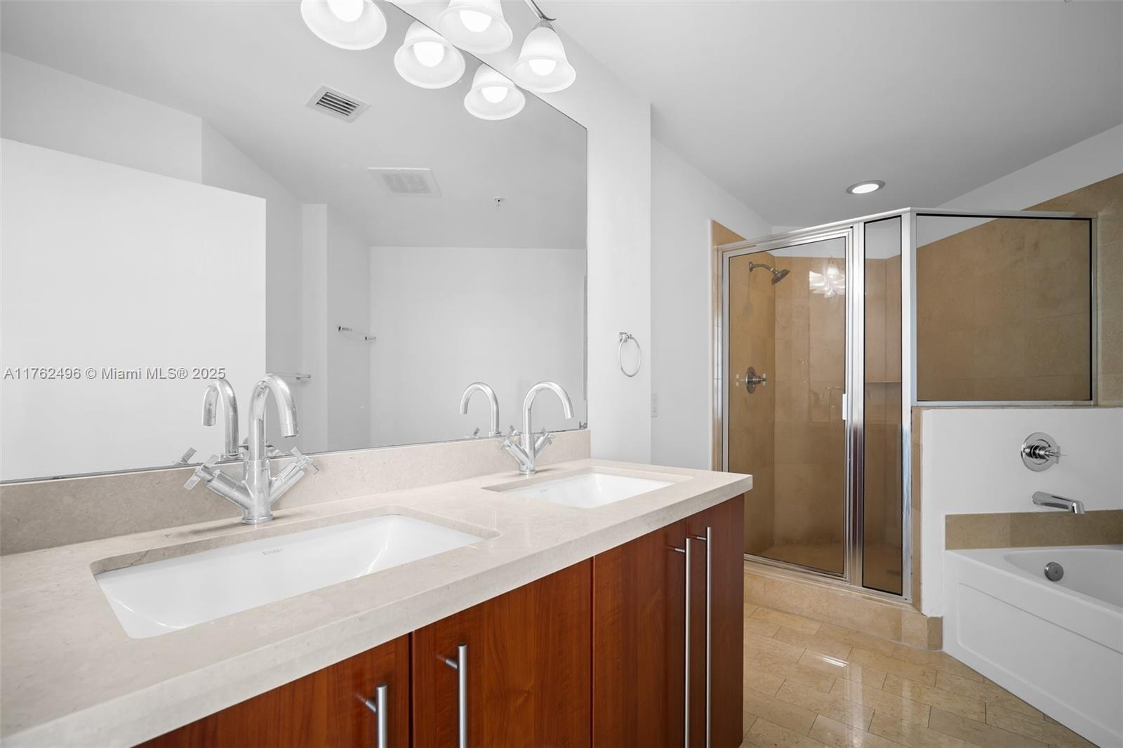 79 Southwest 12th Street, Unit 2512S Miami, FL 33130 - Photo 11 of 36 a bathroom with a sink double vanity granite tub shower and a mirror