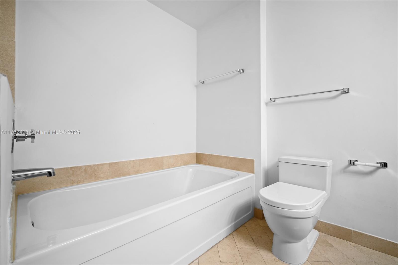 79 Southwest 12th Street, Unit 2512S Miami, FL 33130 - Photo 12 of 36 a white bath tub sitting next to a toilet