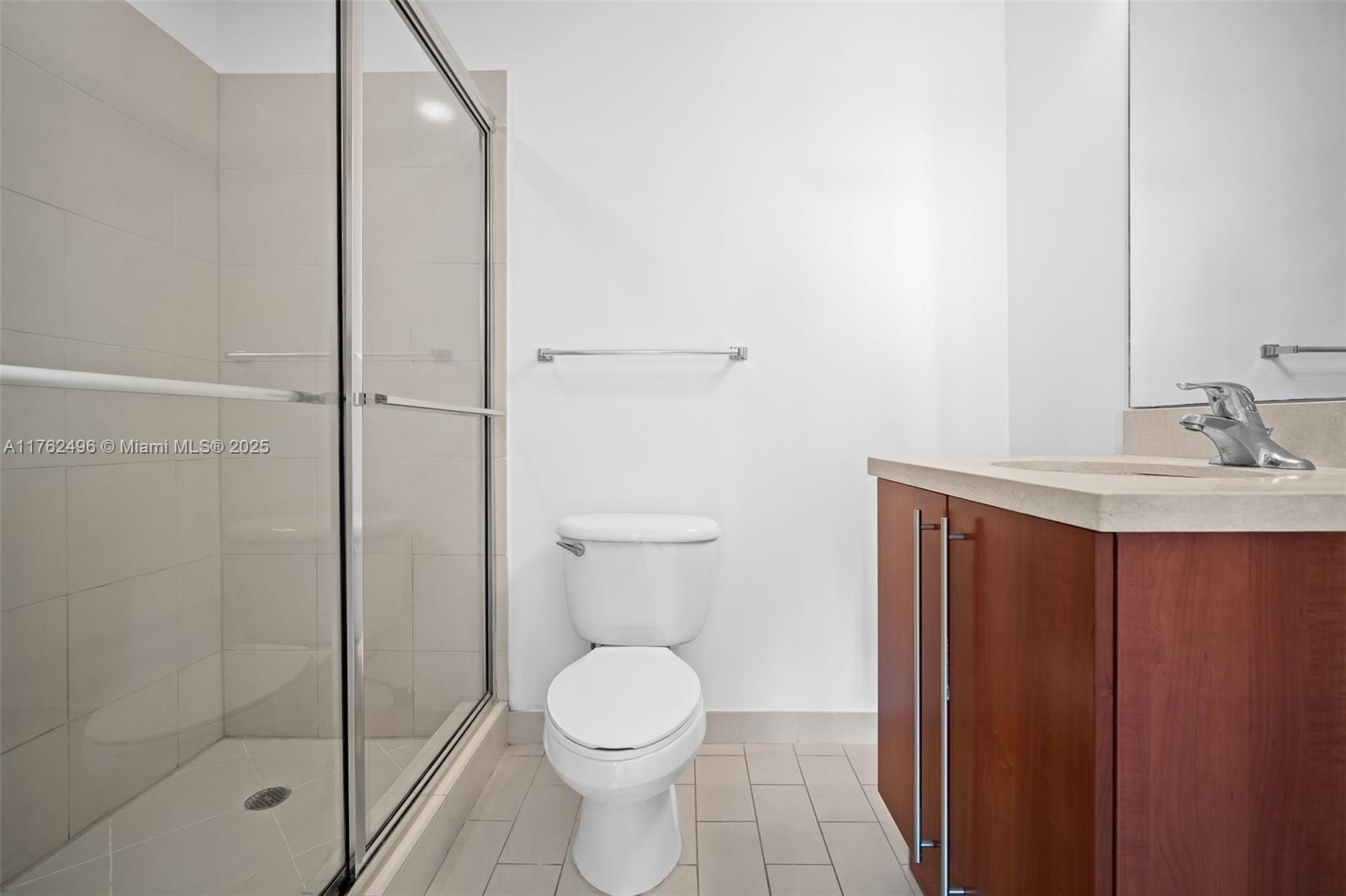 79 Southwest 12th Street, Unit 2512S Miami, FL 33130 - Photo 15 of 36 a bathroom with a sink a toilet and shower