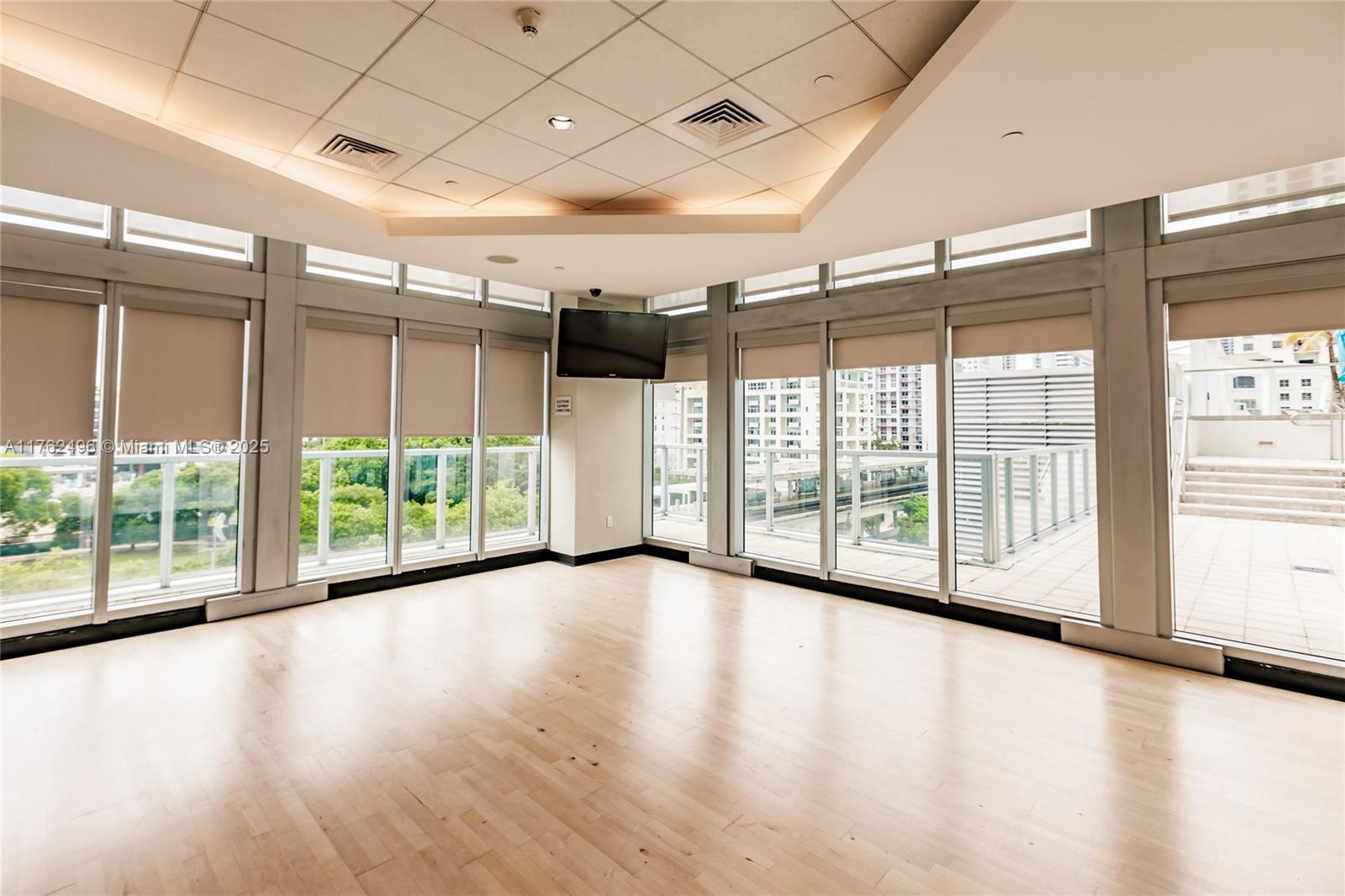 79 Southwest 12th Street, Unit 2512S Miami, FL 33130 - Photo 26 of 36 a view of a livingroom with wooden floor and a large window