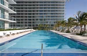 79 Southwest 12th Street, Unit 2512S Miami, FL 33130 - Photo 31 of 36 a view of a swimming pool with a lounge chairs
