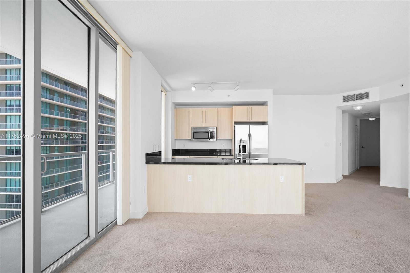 79 Southwest 12th Street, Unit 2512S Miami, FL 33130 - Photo 6 of 36 a kitchen with kitchen island a counter top space and appliances