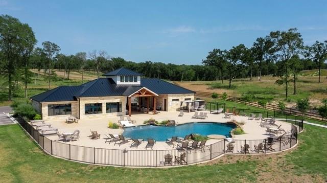 7323 Ranch Oaks Trail Eustace, TX 75124 - Photo 2 of 6 a white house with a yard and lawn chairs under an umbrella