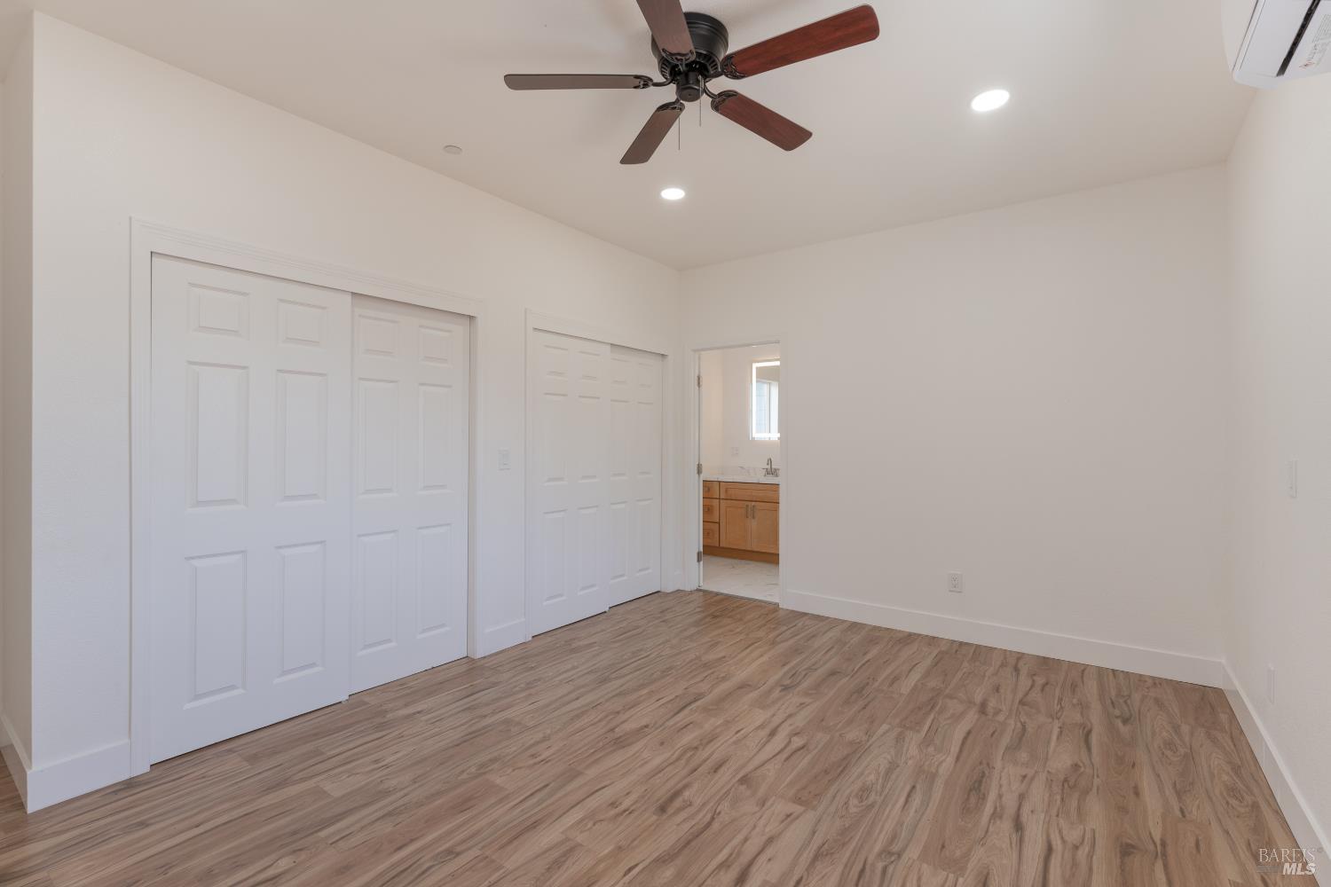 6100 Eastside Calpella Road Ukiah, CA 95482 - Photo 7 of 16 an empty room with wooden floor and windows