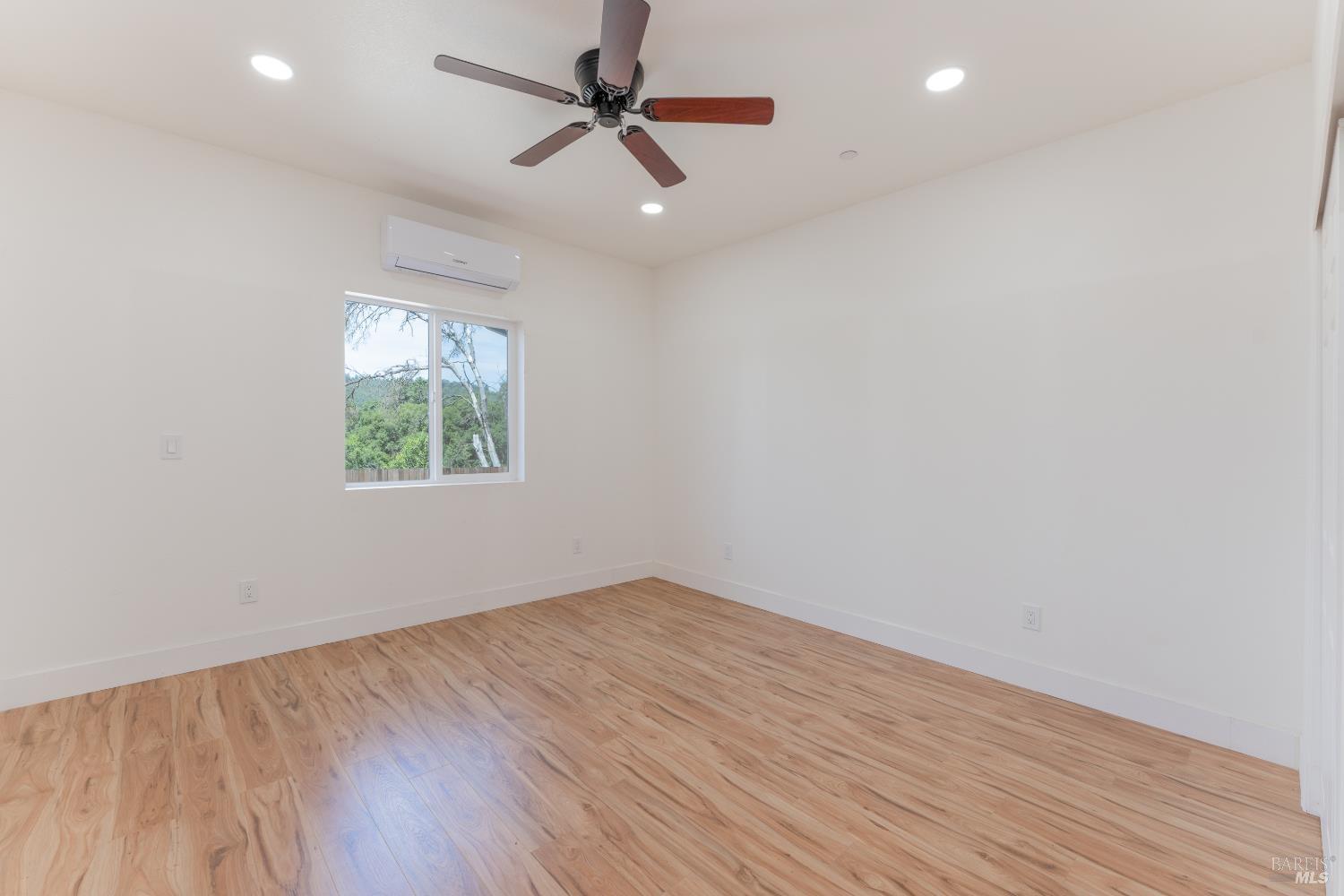 6100 Eastside Calpella Road Ukiah, CA 95482 - Photo 10 of 16 an empty room with wooden floor ceiling fan and windows