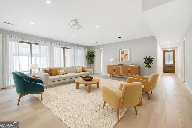 a spacious bedroom with a large bed and a chandelier