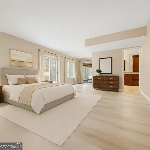 a spacious bathroom with a granite countertop double vanity sink and mirror