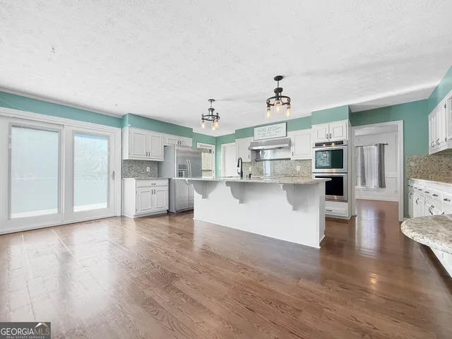 a view of a dining room with furniture wooden floor and chandelier