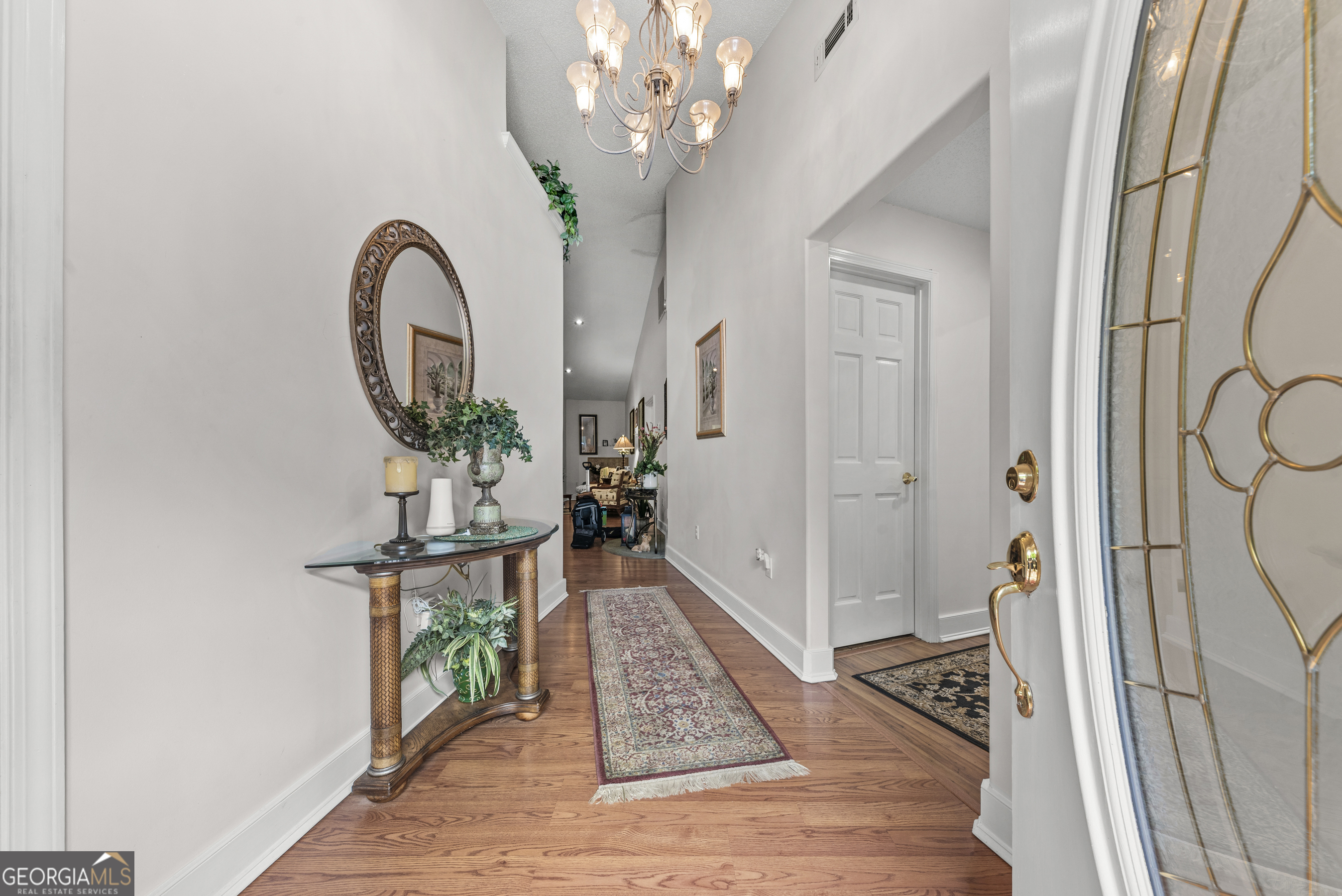 1170 Cedar Grove Road Buckhead, GA 30625 - Photo 4 of 51 a view of a hallway with wooden floor and a chandelier