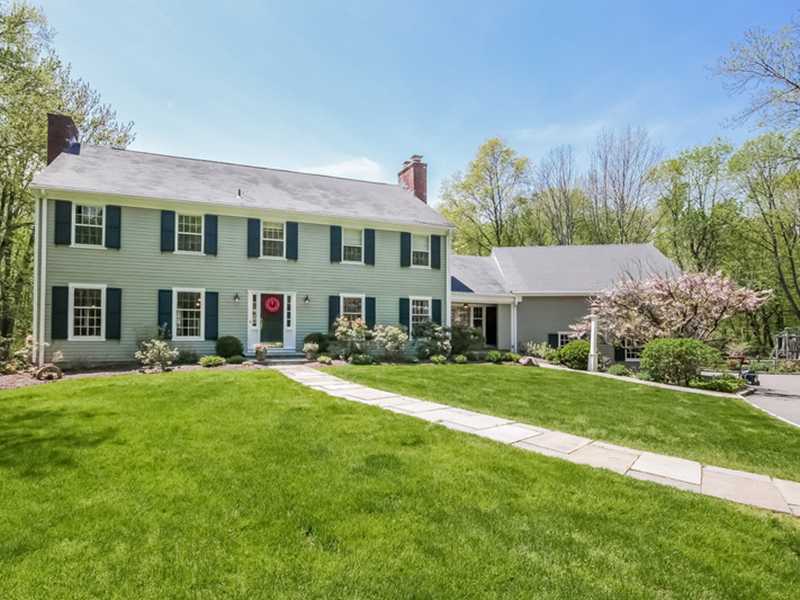 383 Middlesex Road Darien, CT 06820 - Photo 1 of 23 a front view of a house with a garden and pathway