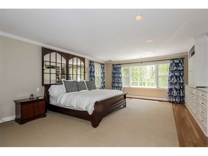 383 Middlesex Road Darien, CT 06820 - Photo 13 of 23 a spacious bedroom with a bed and a large window