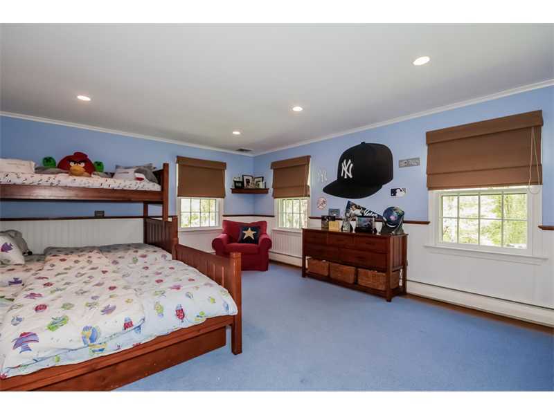 383 Middlesex Road Darien, CT 06820 - Photo 15 of 23 a bedroom with a bed and a dresser with a large window
