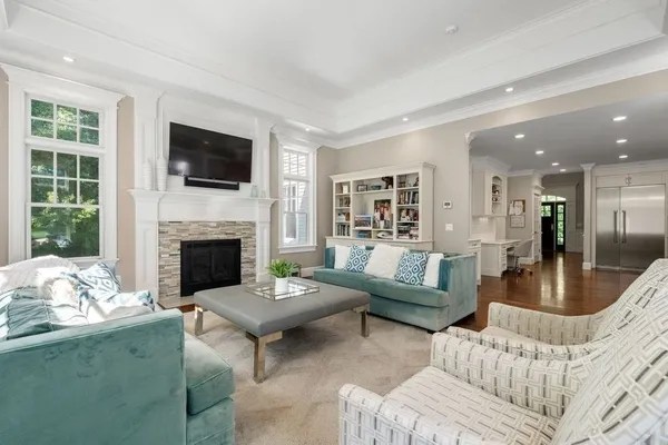 a living room with furniture a flat screen tv and a fireplace